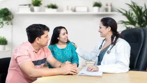 A lady doctor at a women's health clinic consults a young patient during first gynaecologist visit.
